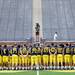 University of Michigan Photo Services photographer Eric Bronson takes a photo of the football team on the 50-yard line during media day at Michigan Stadium on Sunday, August 11, 2013. Melanie Maxwell | AnnArbor.com